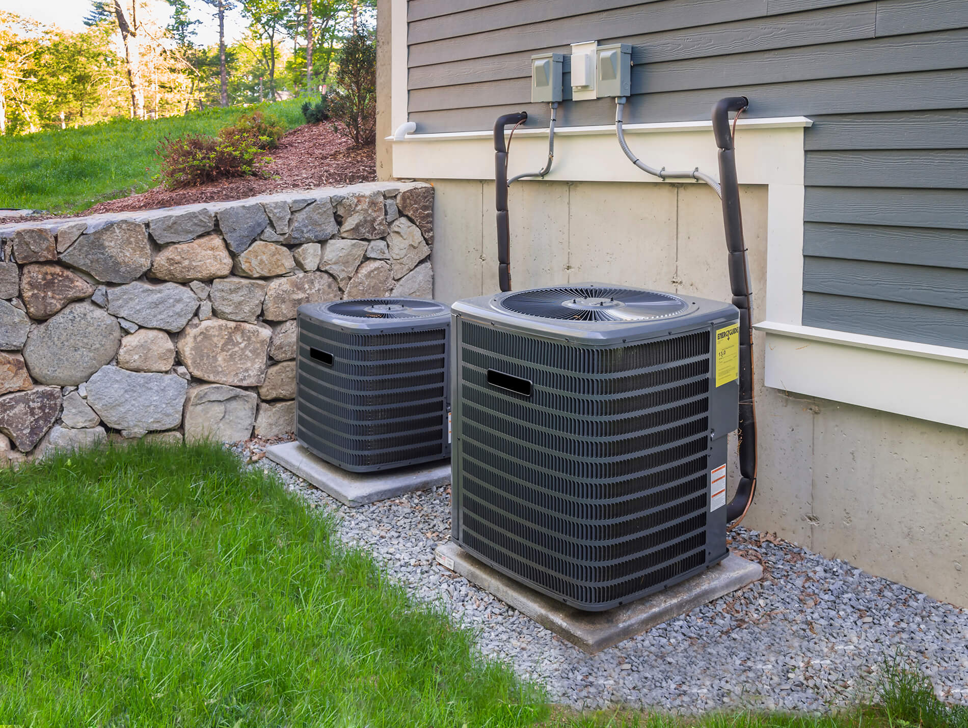 Photo of two AC units outside a beautiful house